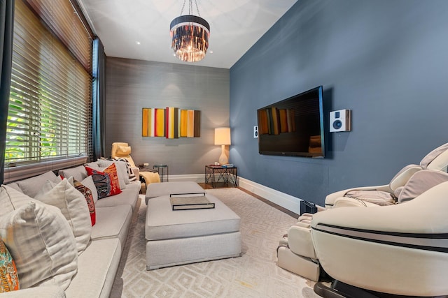 232 Bears Club Dr, Jupiter, FL 33477 - living area featuring wood finished floors, baseboards, and a notable chandelier
