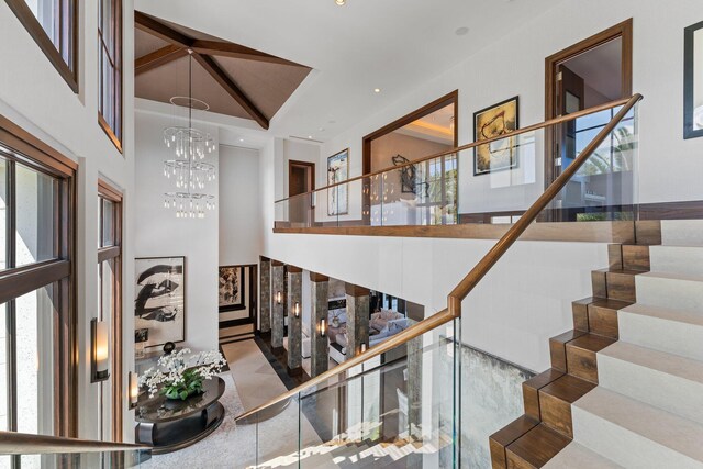 232 Bears Club Dr, Jupiter, FL 33477 - staircase with an inviting chandelier, recessed lighting, and a high ceiling