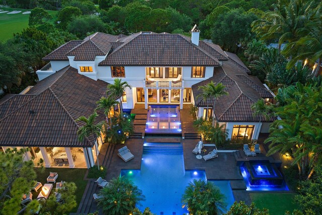 232 Bears Club Dr, Jupiter, FL 33477 - back of property featuring a tile roof, an outdoor hot tub, a gazebo, a balcony, and an outdoor pool