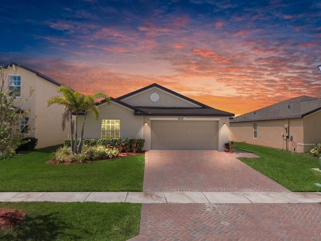 4235 Troon Pl, Fort Pierce, FL 34947 - single story home featuring stucco siding, decorative driveway, a garage, and a yard