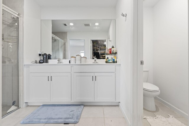 4235 Troon Pl, Fort Pierce, FL 34947 - bathroom with a shower stall, toilet, vanity, a walk in closet, and tile patterned floors