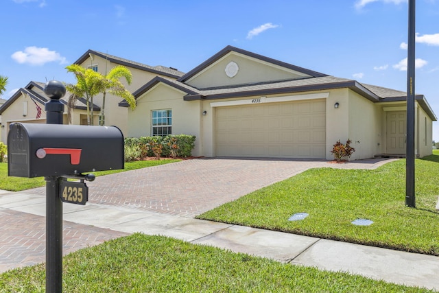 4235 Troon Pl, Fort Pierce, FL 34947 - view of front of home featuring decorative driveway, a garage, stucco siding, and a front lawn