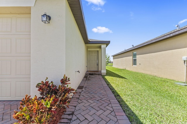 4235 Troon Pl, Fort Pierce, FL 34947 - doorway to property featuring stucco siding and a yard