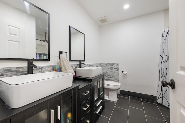 2426 SE Stonecrop St, Port Saint Lucie, FL 34984 - full bathroom with baseboards, tile patterned flooring, toilet, and a sink