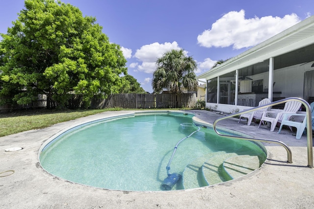 2426 SE Stonecrop St, Port Saint Lucie, FL 34984 - view of swimming pool featuring a sunroom, a patio area, a fenced in pool, and a fenced backyard