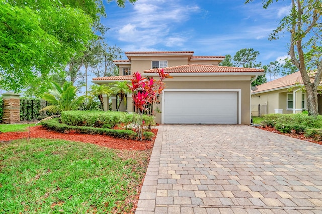 6805 Osage Cir, Greenacres, FL 33413 - mediterranean / spanish home featuring stucco siding, a garage, decorative driveway, and fence