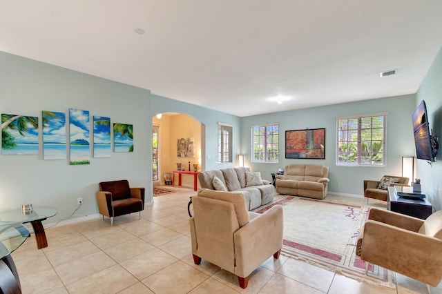 6805 Osage Cir, Greenacres, FL 33413 - living area featuring arched walkways, light tile patterned flooring, and baseboards
