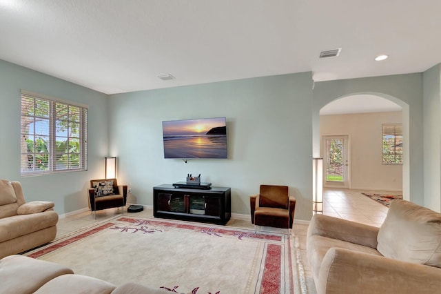 6805 Osage Cir, Greenacres, FL 33413 - tiled living room featuring arched walkways, recessed lighting, and baseboards