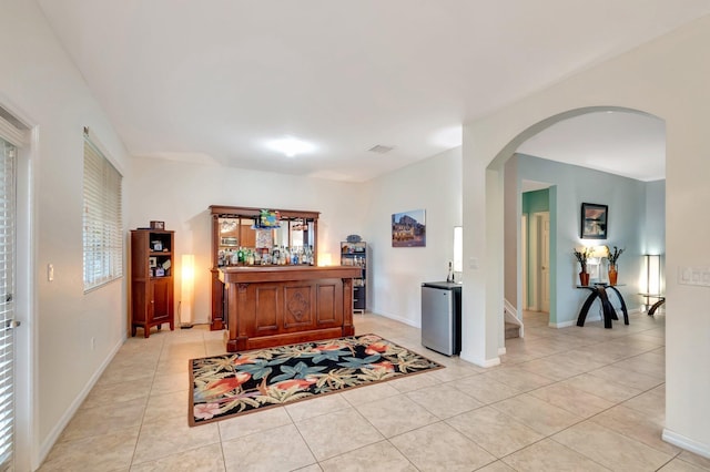 6805 Osage Cir, Greenacres, FL 33413 - office with arched walkways, light tile patterned flooring, a bar, and baseboards