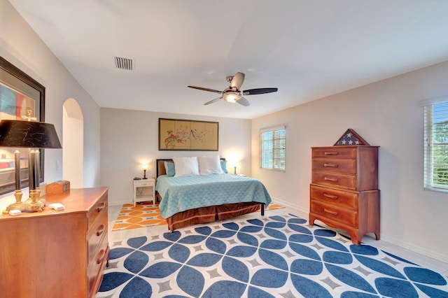 6805 Osage Cir, Greenacres, FL 33413 - bedroom with baseboards, multiple windows, arched walkways, and a ceiling fan
