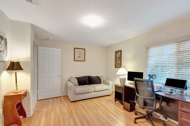 6805 Osage Cir, Greenacres, FL 33413 - office featuring light wood-style flooring, a textured ceiling, and baseboards