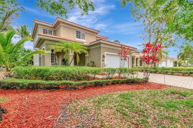 6805 Osage Cir, Greenacres, FL 33413 - mediterranean / spanish house with a garage, stucco siding, decorative driveway, and a tile roof