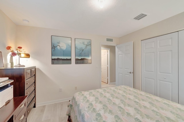 6805 Osage Cir, Greenacres, FL 33413 - bedroom featuring a closet, baseboards, and light wood finished floors