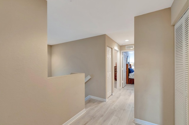 6805 Osage Cir, Greenacres, FL 33413 - corridor with an upstairs landing, baseboards, light wood-style flooring, and recessed lighting
