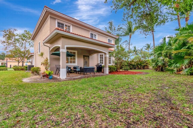 6805 Osage Cir, Greenacres, FL 33413 - rear view of house featuring stucco siding, a yard, and a patio area
