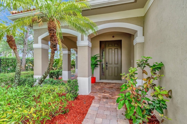 6805 Osage Cir, Greenacres, FL 33413 - property entrance with stucco siding and a porch