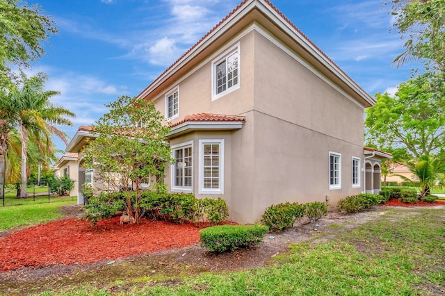 6805 Osage Cir, Greenacres, FL 33413 - view of home's exterior with stucco siding and a tiled roof