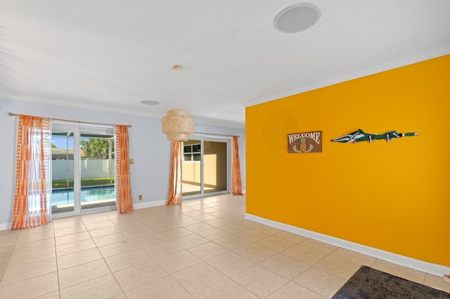 2650 NE 22nd St, Pompano Beach, FL 33062 - unfurnished room with crown molding, baseboards, and light tile patterned flooring