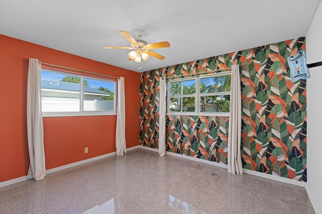 2650 NE 22nd St, Pompano Beach, FL 33062 - spare room featuring baseboards, a ceiling fan, a textured ceiling, and granite tiled floors