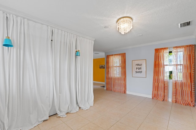 2650 NE 22nd St, Pompano Beach, FL 33062 - unfurnished room with baseboards, ornamental molding, a textured ceiling, and light tile patterned flooring