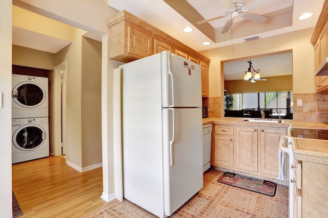 1961 SW 15th St Unit 82, Deerfield Beach, FL 33442 - kitchen featuring white appliances, stacked washing machine and dryer, light brown cabinets, and recessed lighting