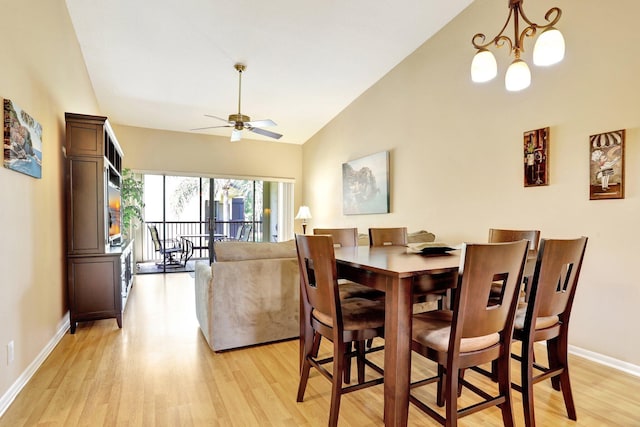 1961 SW 15th St Unit 82, Deerfield Beach, FL 33442 - dining space with light wood finished floors, baseboards, a ceiling fan, high vaulted ceiling, and a chandelier