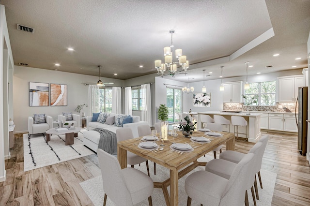 179 Tresana Blvd Unit 145, Jupiter, FL 33478 - dining room featuring a chandelier, recessed lighting, light wood-type flooring, and a textured ceiling