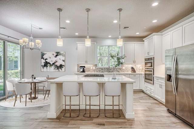 179 Tresana Blvd Unit 145, Jupiter, FL 33478 - kitchen with appliances with stainless steel finishes, plenty of natural light, light countertops, recessed lighting, and decorative backsplash