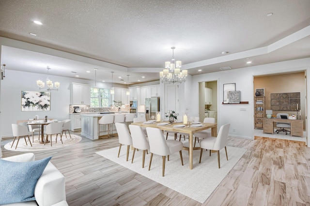 179 Tresana Blvd Unit 145, Jupiter, FL 33478 - dining area featuring a chandelier, light wood finished floors, recessed lighting, a textured ceiling, and baseboards