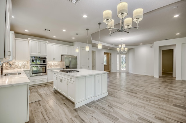 179 Tresana Blvd Unit 145, Jupiter, FL 33478 - kitchen featuring a sink, appliances with stainless steel finishes, a chandelier, recessed lighting, and tasteful backsplash