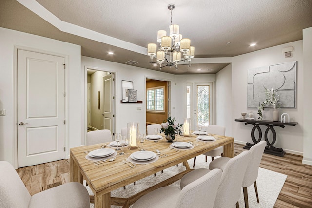 179 Tresana Blvd Unit 145, Jupiter, FL 33478 - dining room featuring a chandelier, recessed lighting, light wood finished floors, baseboards, and a textured ceiling