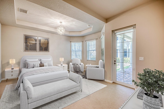 179 Tresana Blvd Unit 145, Jupiter, FL 33478 - bedroom with access to exterior, baseboards, a chandelier, and light colored carpet