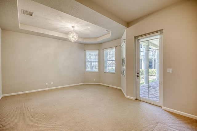 179 Tresana Blvd Unit 145, Jupiter, FL 33478 - unfurnished room featuring healthy amount of natural light, light colored carpet, baseboards, and a textured ceiling