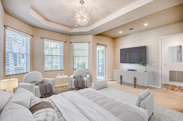 179 Tresana Blvd Unit 145, Jupiter, FL 33478 - bedroom with a chandelier, baseboards, carpet flooring, a raised ceiling, and recessed lighting