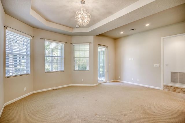 179 Tresana Blvd Unit 145, Jupiter, FL 33478 - spare room with a chandelier, baseboards, light colored carpet, a tray ceiling, and recessed lighting