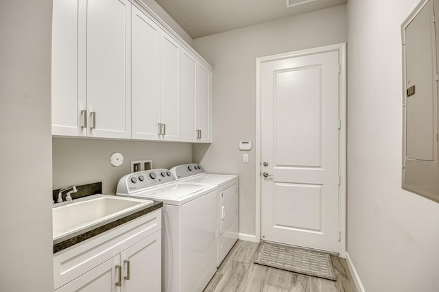179 Tresana Blvd Unit 145, Jupiter, FL 33478 - washroom featuring washing machine and clothes dryer, cabinet space, light wood finished floors, and baseboards