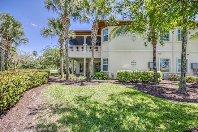179 Tresana Blvd Unit 145, Jupiter, FL 33478 - rear view of property with stucco siding and a yard