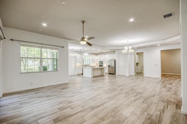 179 Tresana Blvd Unit 145, Jupiter, FL 33478 - unfurnished living room featuring a chandelier, ceiling fan, light wood-style flooring, baseboards, and recessed lighting