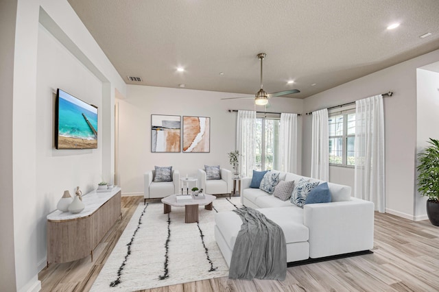 179 Tresana Blvd Unit 145, Jupiter, FL 33478 - living room with baseboards, light wood finished floors, a textured ceiling, recessed lighting, and a ceiling fan