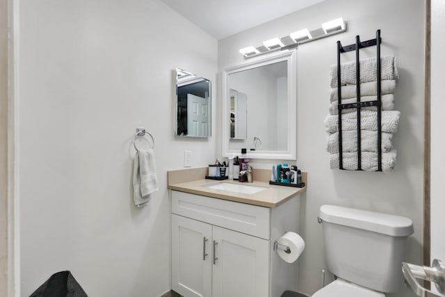 half bathroom with toilet and vanity
