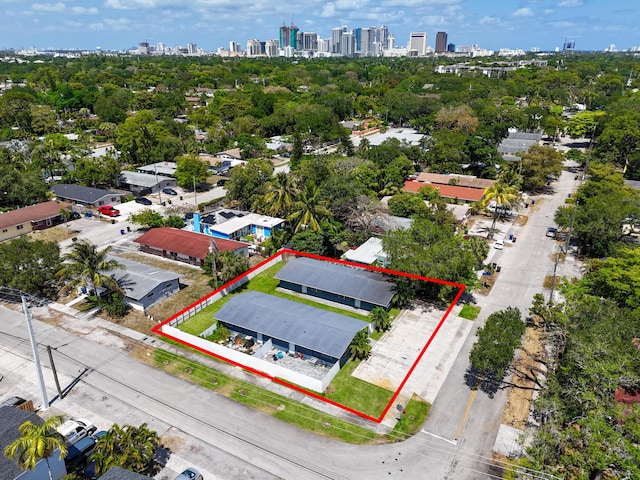 aerial view of property's location with a skyline view, property boundaries highlighted, and a tree filled landscape