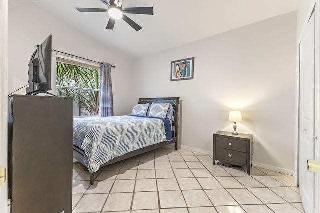 bedroom featuring vaulted ceiling, ceiling fan, baseboards, and light tile patterned floors