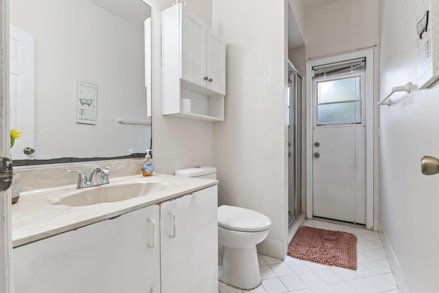 full bathroom with toilet, a stall shower, tile patterned floors, baseboards, and vanity