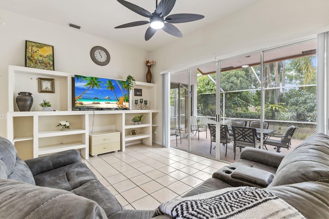 living area with a sunroom, light tile patterned floors, visible vents, and a ceiling fan