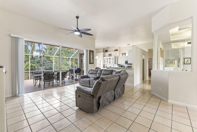 living area with light tile patterned floors, visible vents, baseboards, and ceiling fan