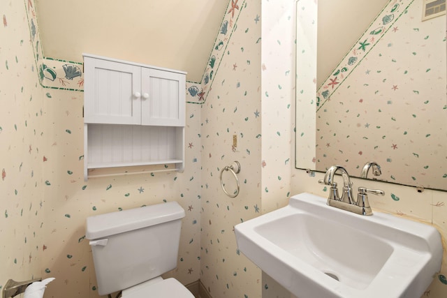 3003 Fairway Dr N, Jupiter, FL 33477 - bathroom with a sink, wallpapered walls, and toilet