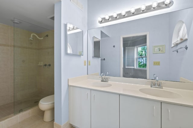 3003 Fairway Dr N, Jupiter, FL 33477 - bathroom with a tile shower, toilet, tile patterned flooring, and double vanity
