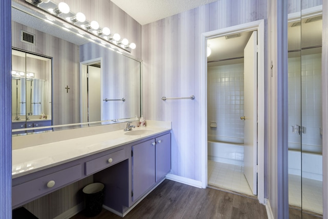 13403 Touchstone Pl Unit A-202, Palm Beach Gardens, FL 33418 - bathroom with wallpapered walls, vanity, wood finished floors, and baseboards