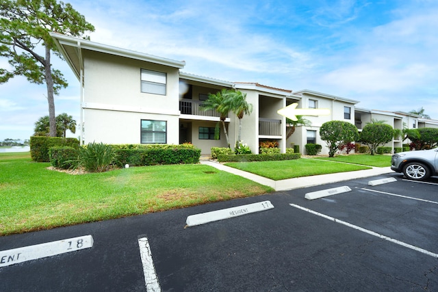 13403 Touchstone Pl Unit A-202, Palm Beach Gardens, FL 33418 - view of building exterior featuring uncovered parking