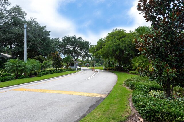 13403 Touchstone Pl Unit A-202, Palm Beach Gardens, FL 33418 - view of asphalt street with street lighting and view of wooded area